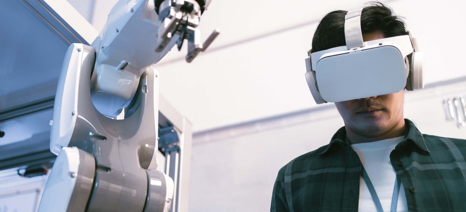 A student in a lab setting uses a VR headset and a hand-held controller to augment his learning.